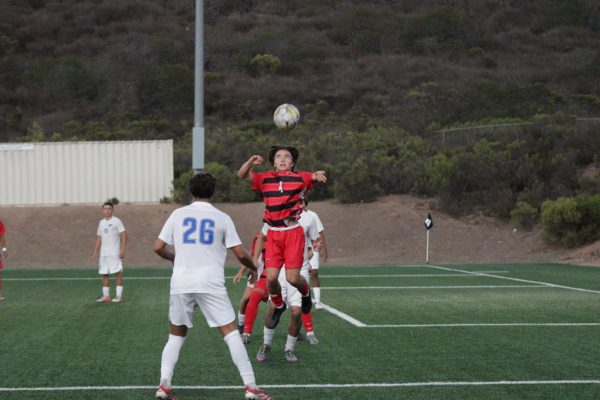 Palomar's Colin Goss (#4) jumps to attempt to retrieve the ball that's above his head to make a goal after a corner kick play from Palomar.