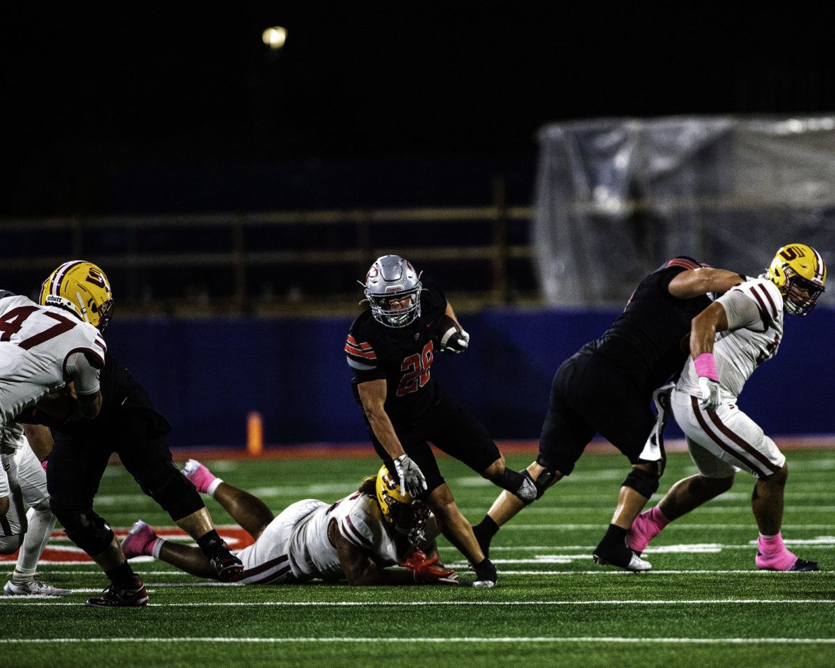 Palomar College running back Logan Cella (#28) runs past Saddleback College Iosefa Tapeni (#55)  during the third quarter on Oct 25 2025 at the Palomar College Stadium. Photo credit: Evan Odom