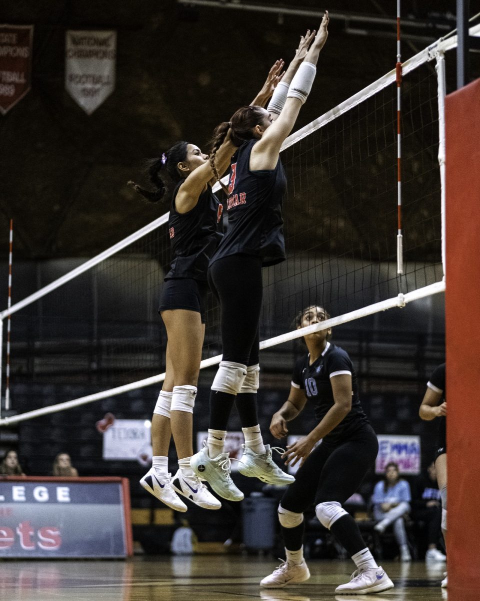 Palomar College middle blocker Teiora Tinoisamoa (#6) (right) and outside hitter Reese Maffit (#9) (left) attempt to block a spike against Miramar College on Nov. 5 2025 at the Palomar College Dome.
