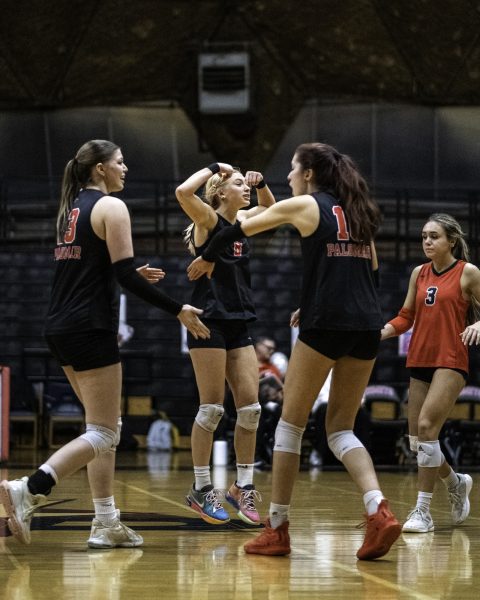 (From left to right) Palomar College middle blocker Sierra Shoenwald (#13), setter Caden Pinto (#8), middle blocker Dovie Daniels (#10), and libero Kiana Merril (#3) closing in together after a long volley in the fourth set against Miramar College on Nov. 5 2025 at The Palomar College Dome.
