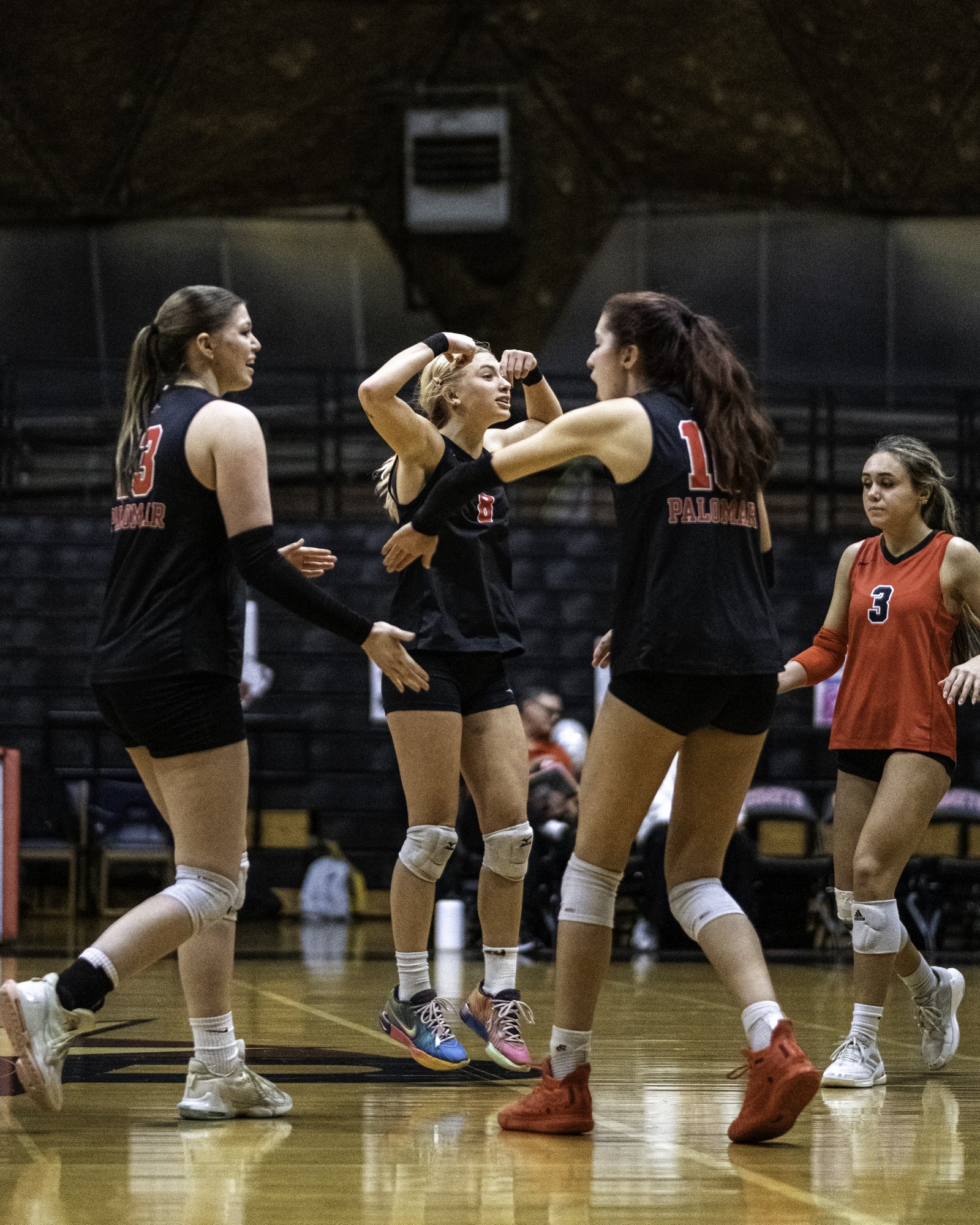 (From left to right) Palomar College middle blocker Sierra Shoenwald (#13), setter Caden Pinto (#8), middle blocker Dovie Daniels (#10), and libero Kiana Merril (#3) closing in together after a long volley in the fourth set against Miramar College on Nov. 5 2025 at The Palomar College Dome.