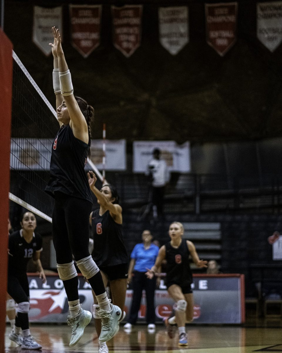 Palomar College outside hitter Reese Maffit (#9) jumps to protect against a spike from Miramar College on Nov. 5 2025 at The Palomar College Dome.