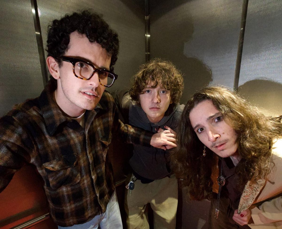 Band members, Nathan Rosenthal (left), Gavin Cann (center) and Gabriel Rosenthal (right), in an elevator on campus.