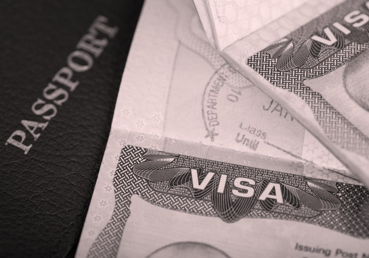 A USCIS memo issued Dec. 2 required additional screening for certain cases from 19 countries, leaving many applicants unsure when processing will resume. (Made with Canva)