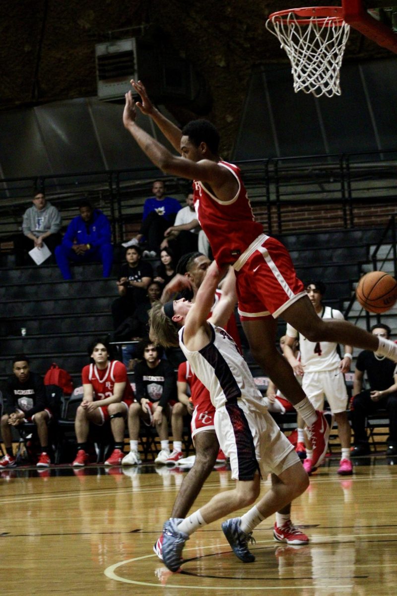 Benjie Nudo (#0) looks up at the Bakersfield player who is blocking his path to the basket.