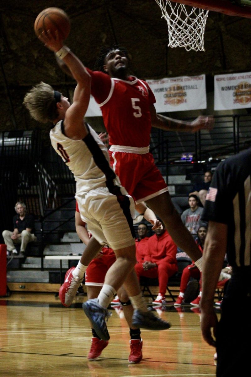 Benjie Nudo (#0) has the basketball, shoots a layup as a Bakersfield player attempts to block.