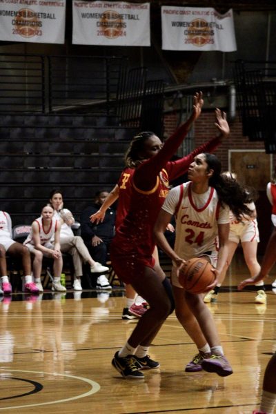 Ivorii Seals in a white jersey attempts to make a shot while Pasadena City's player blocks Seals on Feb. 25 at The Dome.