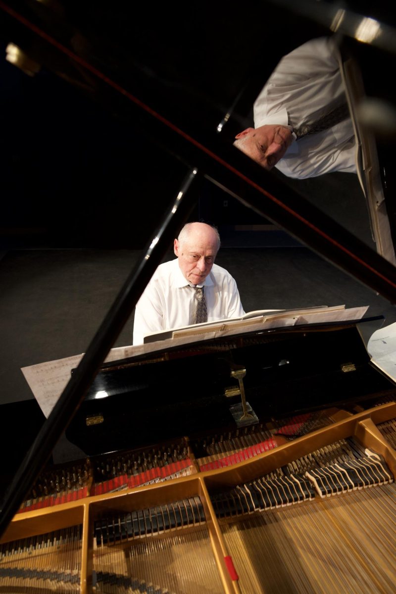 Pianist Dmitry Kirichenko reflected in the raised lid of a grand piano during Palomar College’s free Concert Hour series in the Performance Lab on Oct. 2, 2025.