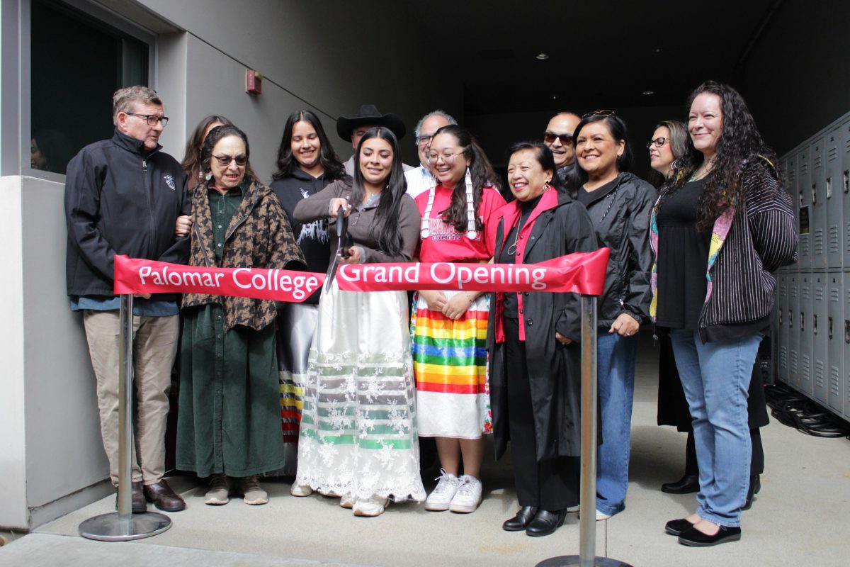 Monica Scott, the president of the Native American Student Alliance, cuts the ribbon at the grand reopening of the Native American Resource Center on Feb. 20 at Palomar College.