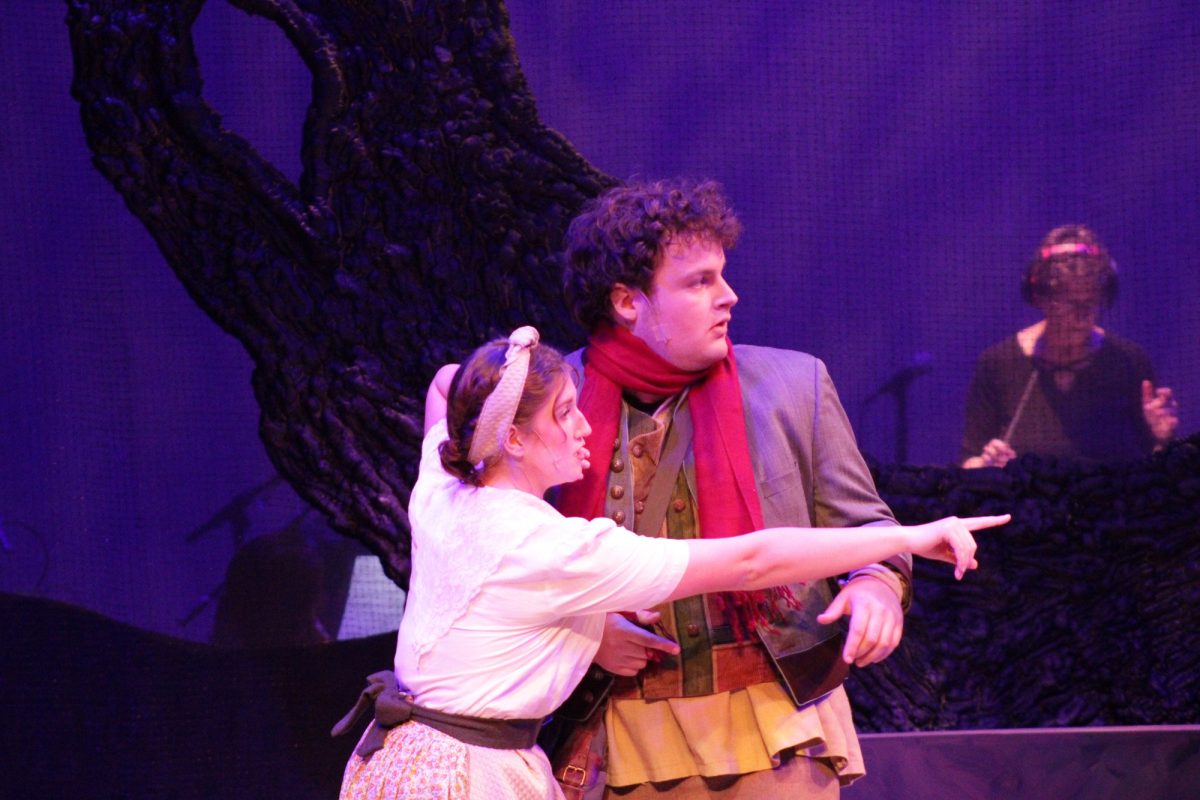 Autumn Lowe (the Baker's Wife) and Caleb Wohlgemuth (the Baker) look at another character for Into the Woods during tech rehearsal in March. 3 at the Howard Brubeck Theater. 