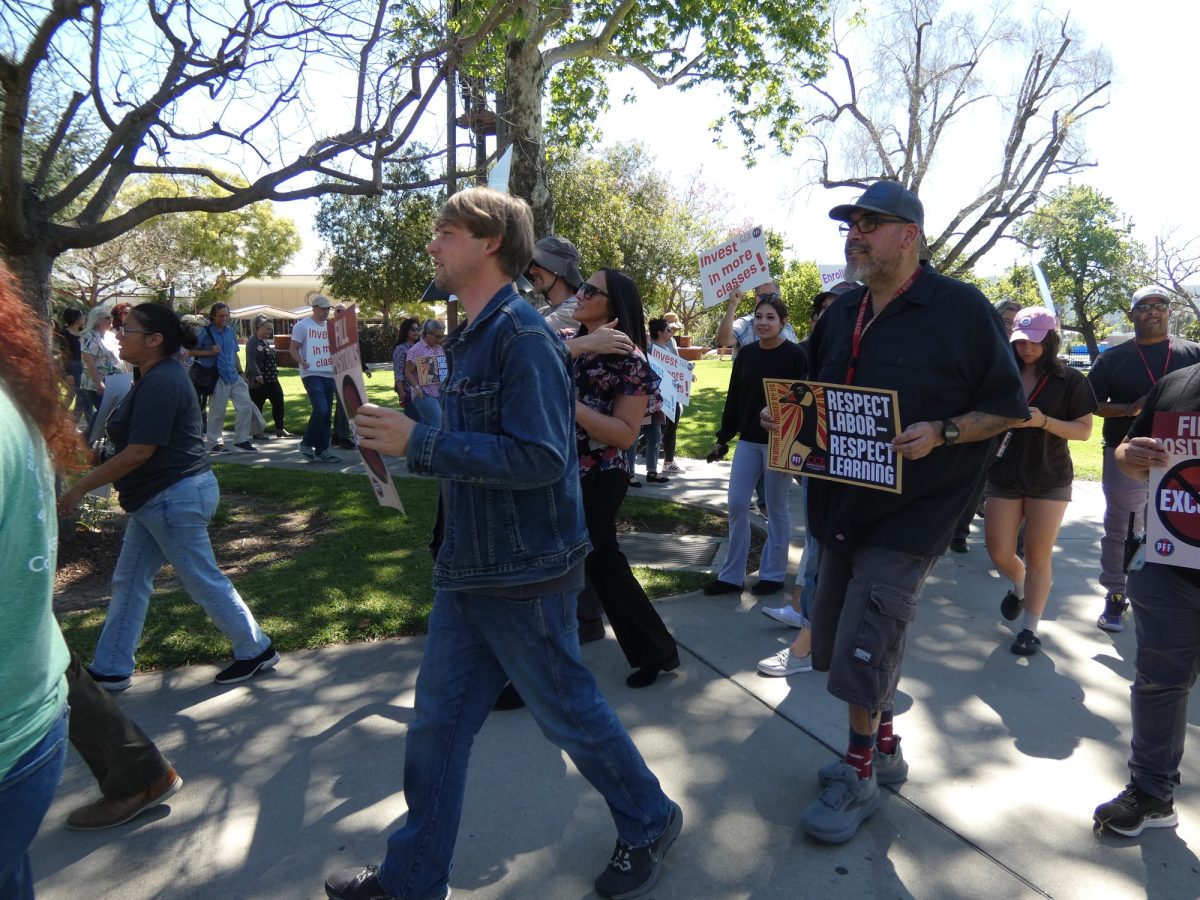 Attendees marching on March, 12, 2026 alongside the Clock Tower Lawn at Palomar College. 