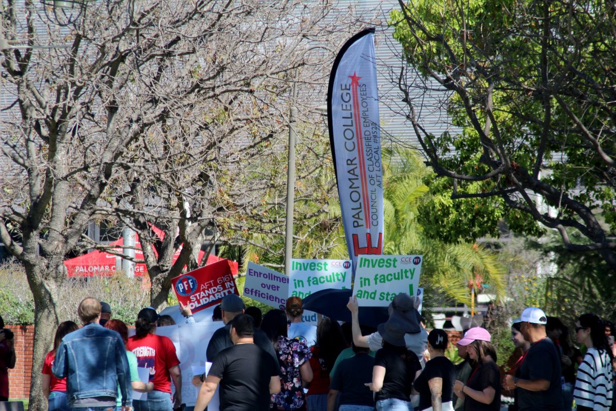 "March In March" participants hold signs advocating from their cause on March 12, 2026 at Palomar College in San Marcos. 