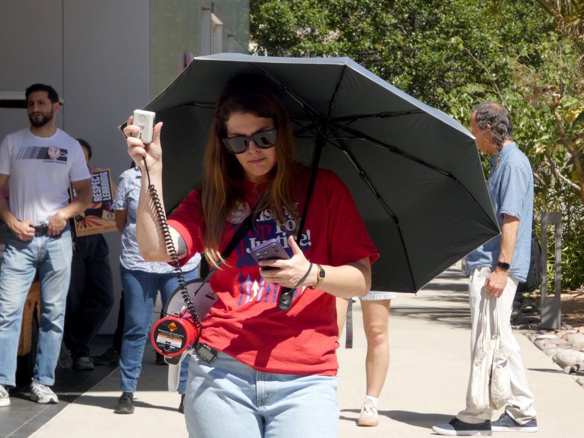 Jena Kruhmin, CCE Vice President of Membership, leads a chant at the "March in March" event on March 12, 2026  in the LRC Plaza. 