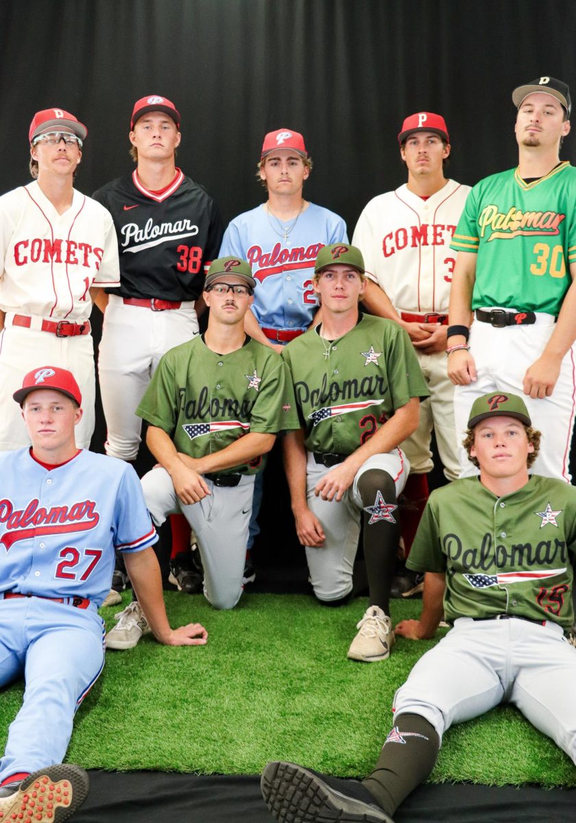 Palomar baseball players pose closely together in a variety of jersey colors.