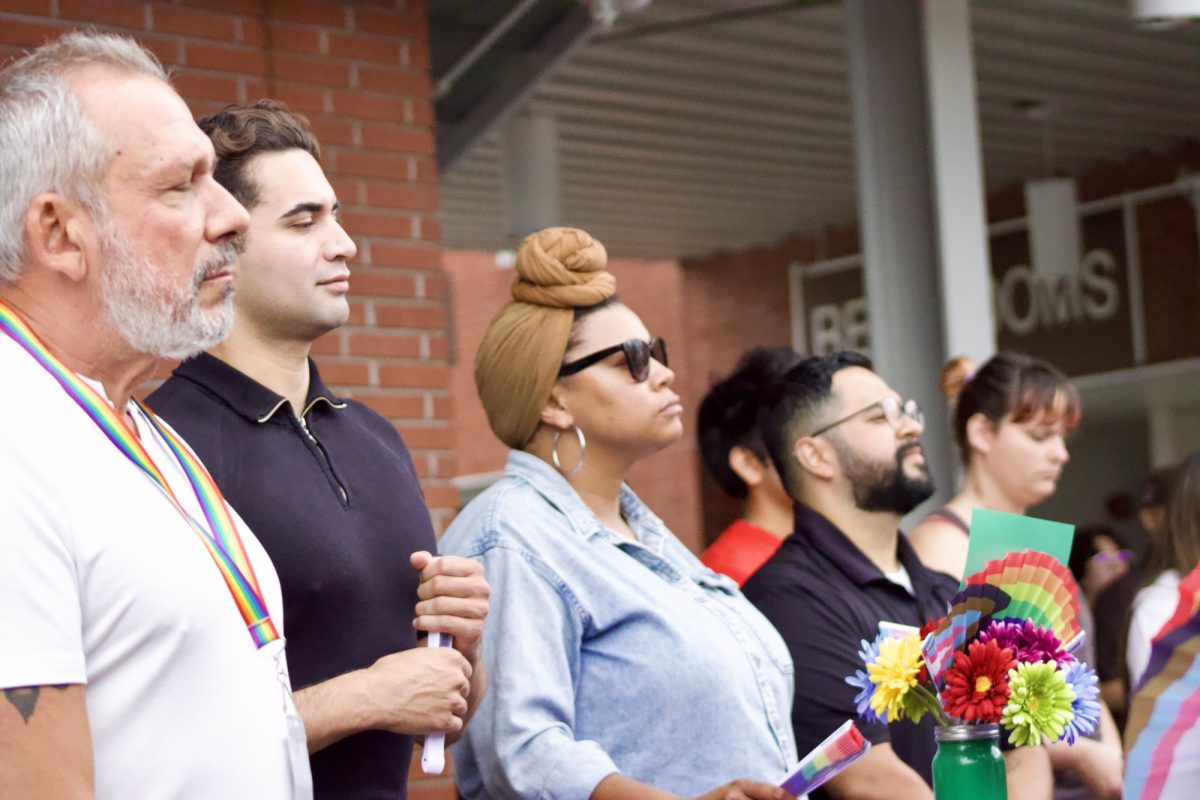 From left to right: Max Disposti, Jacob Duarte, Kenyatta Parker, and Juan Esparza are standing in a line looking at the presenter.