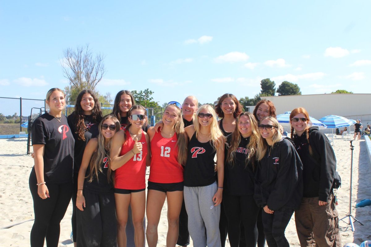 The Palomar College beach Volleyball team pose with players Emma Bambe and Reese Maffitt after their Match against MiraCosta.