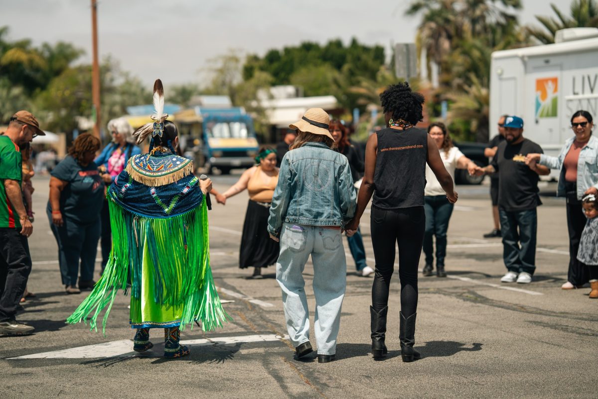 Guest speaker Kiara Love Flores joins a dance with the crowd at the Solidarity & Strength Community Festival on May 2. 