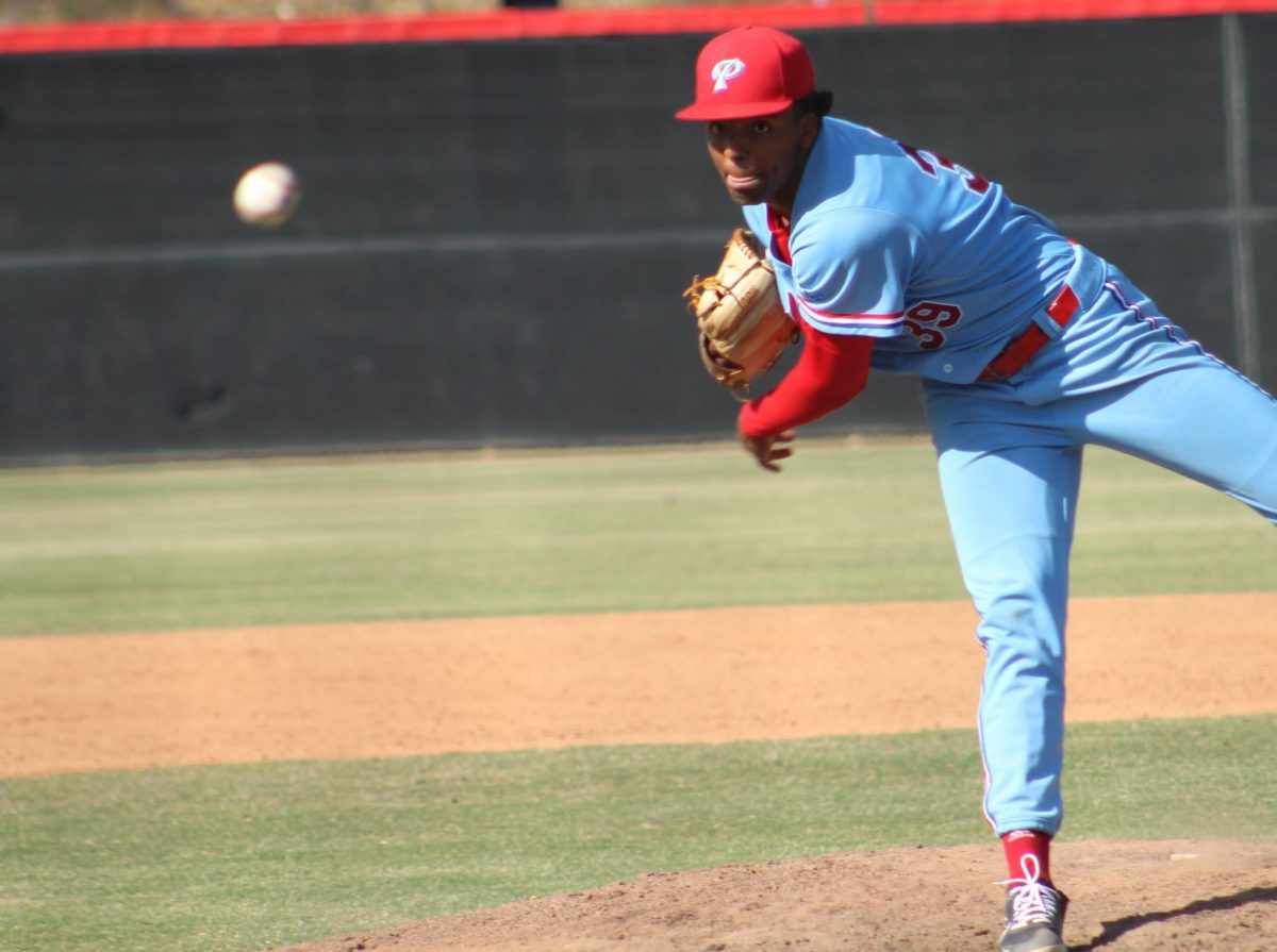 A left-handed Palomar baseball pitcher stands on his right leg and leans forward just after throwing a pitch.