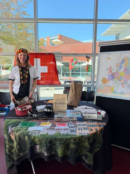 Table with German cultural items, including a Swiss flag and European map in the Student Union.